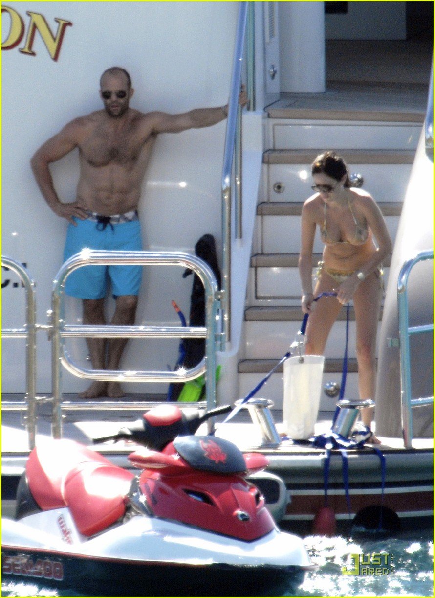 Jason Statham with his wife on sunbeds