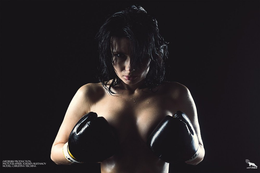Girl with raised hands topless