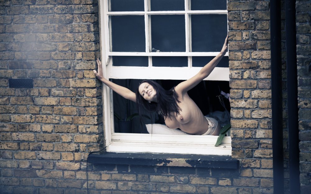 Naked women in the windows of houses