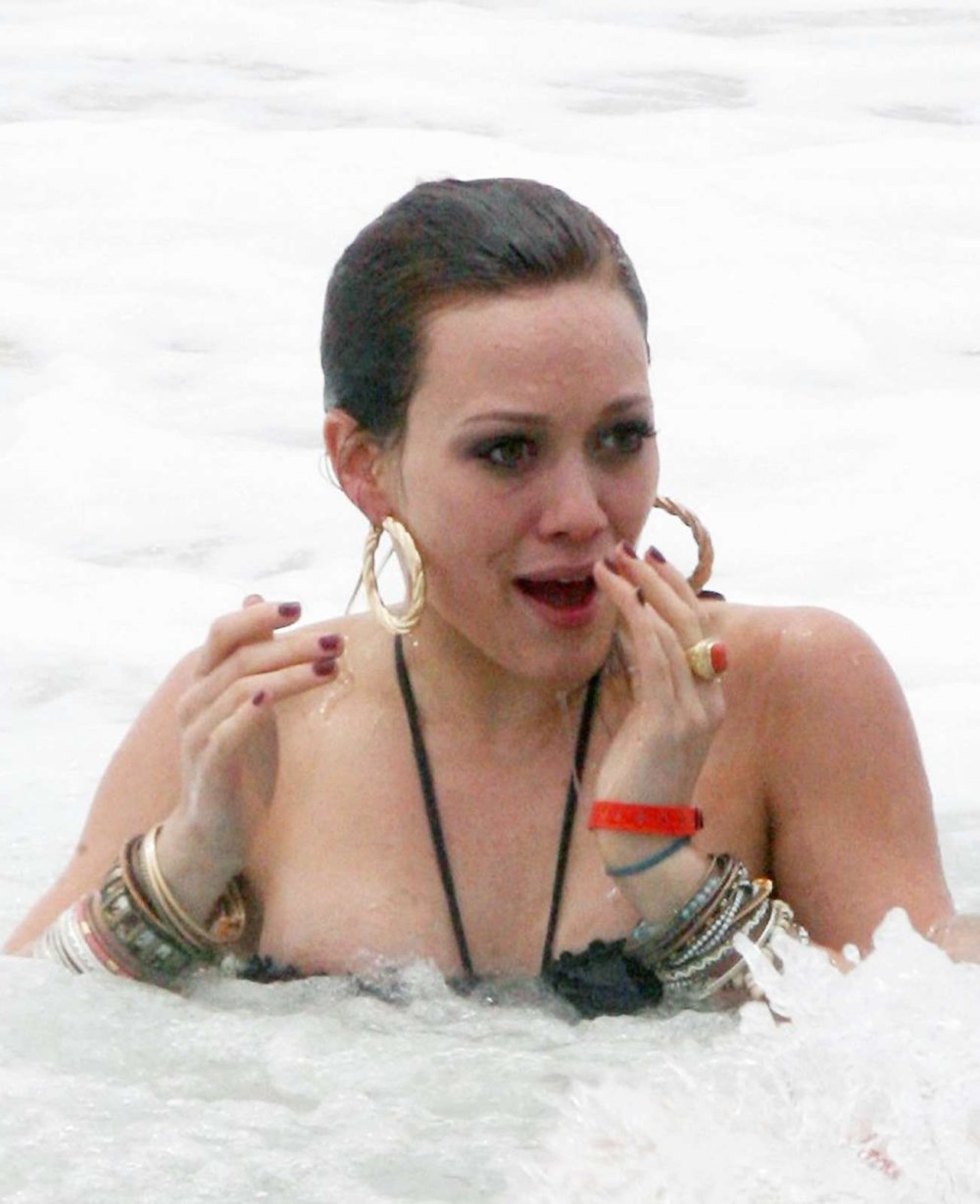 Hilary Duff in a pink bikini rests in Malibu (07/09/2017)