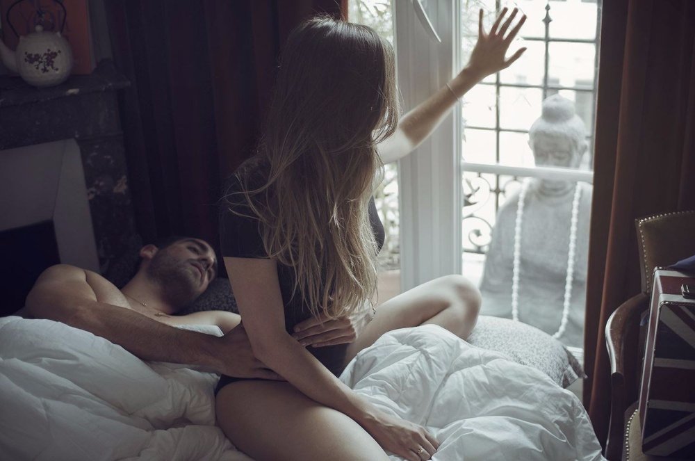 A man hugs a woman behind
