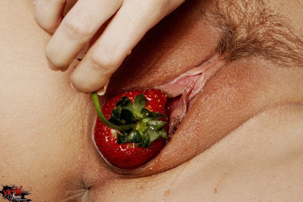 Strawberry in a girl's pussy