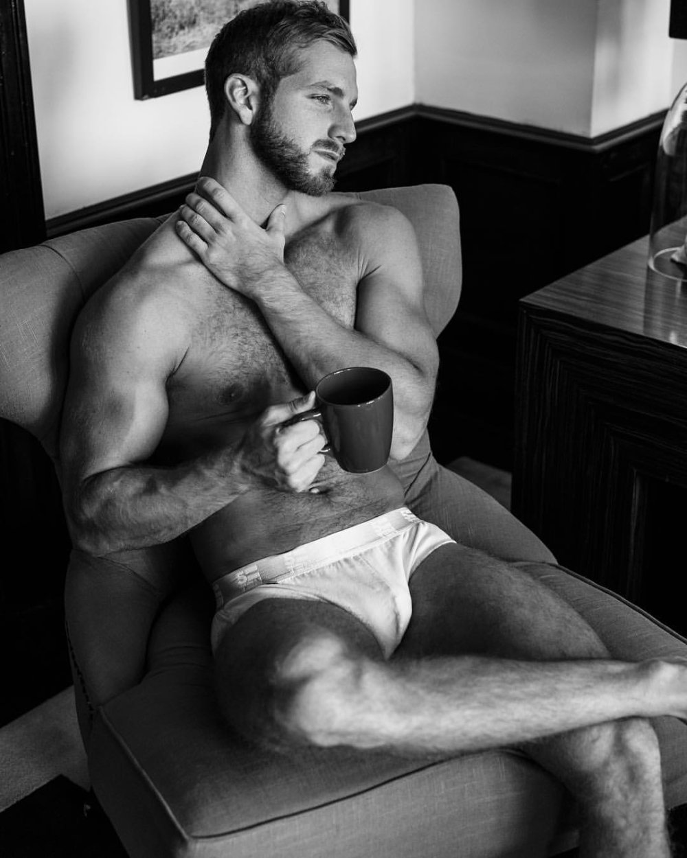 Brutal man with coffee sits naked gif