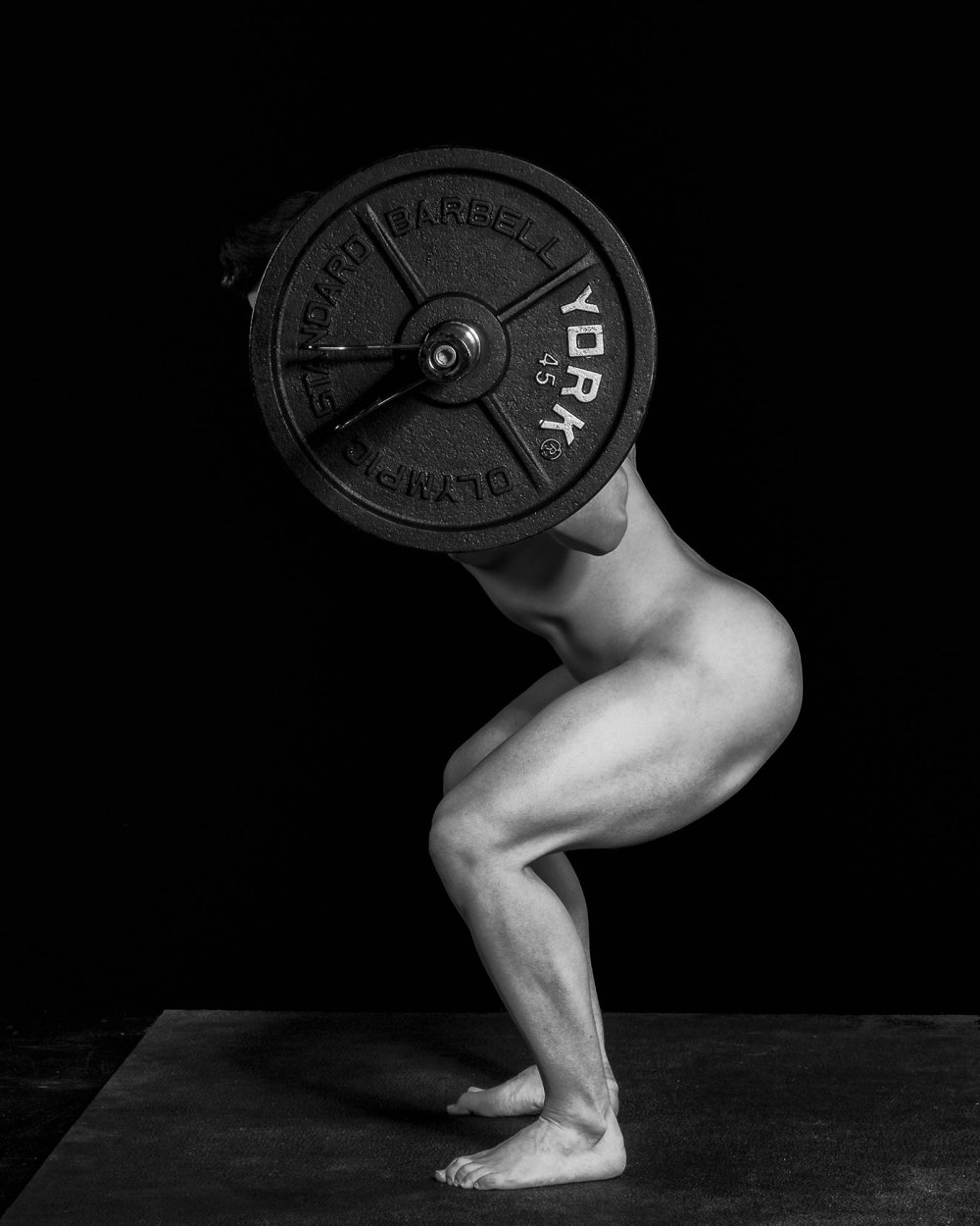 Naked crouches with a barbell