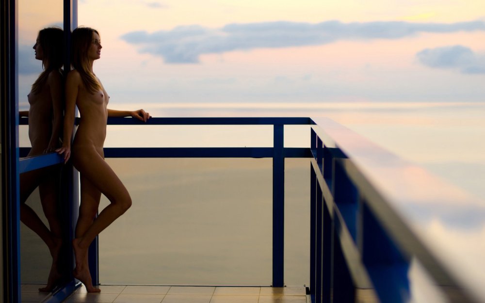 Naked blonde on the balcony
