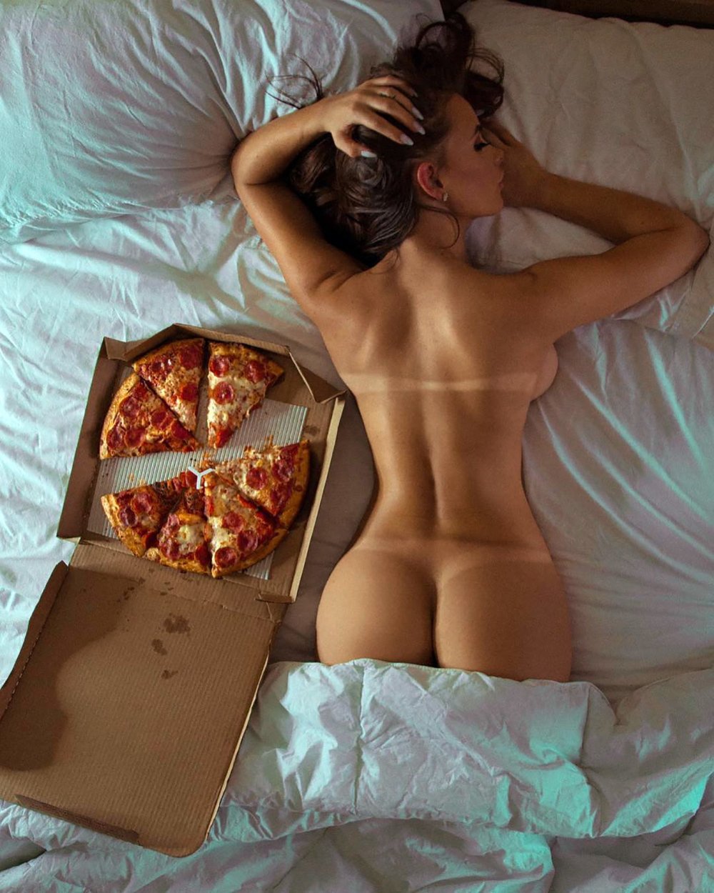 A naked guy with a hard on lying on a Table