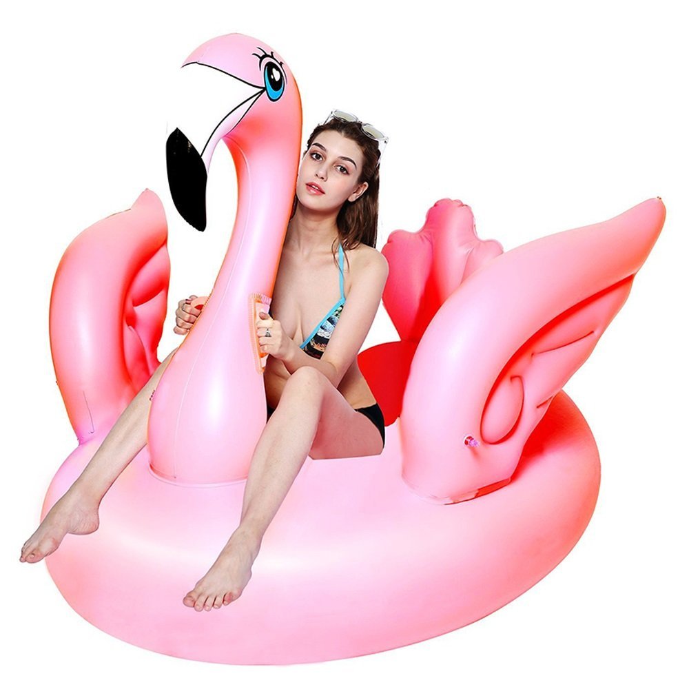 Girl on inflatable flamingos