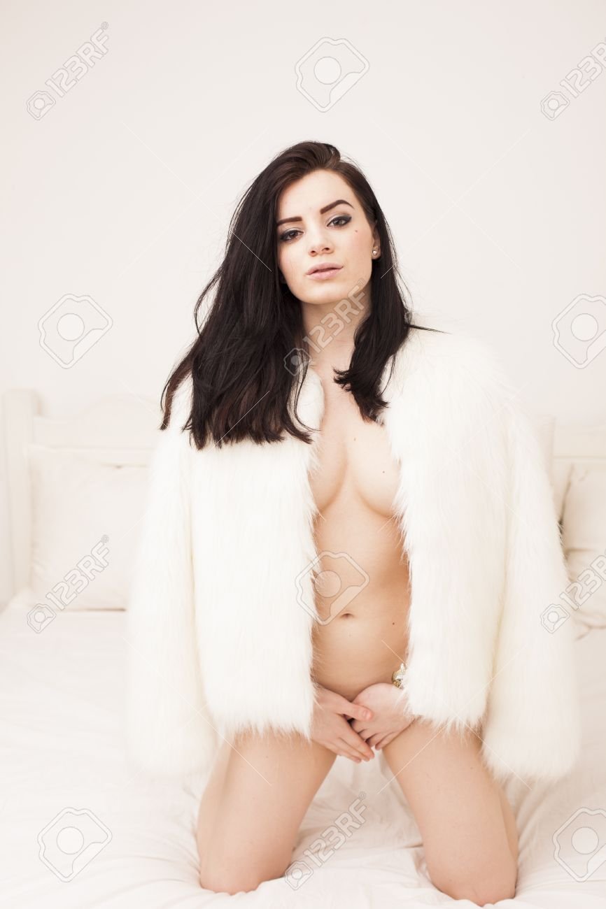Woman in a fur coat on a naked body