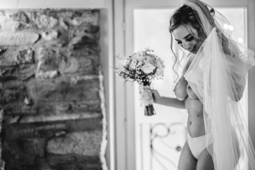 Naked blonde in a white dress