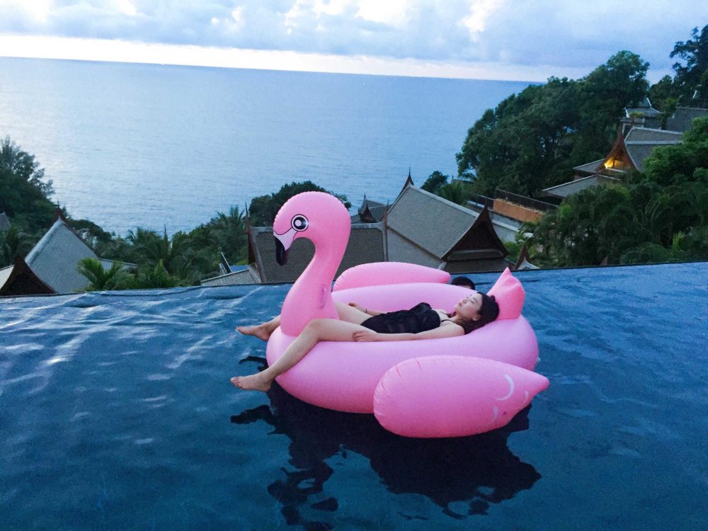 Girl on inflatable flamingos