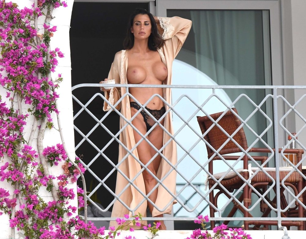 Beauty with big tits on the balcony
