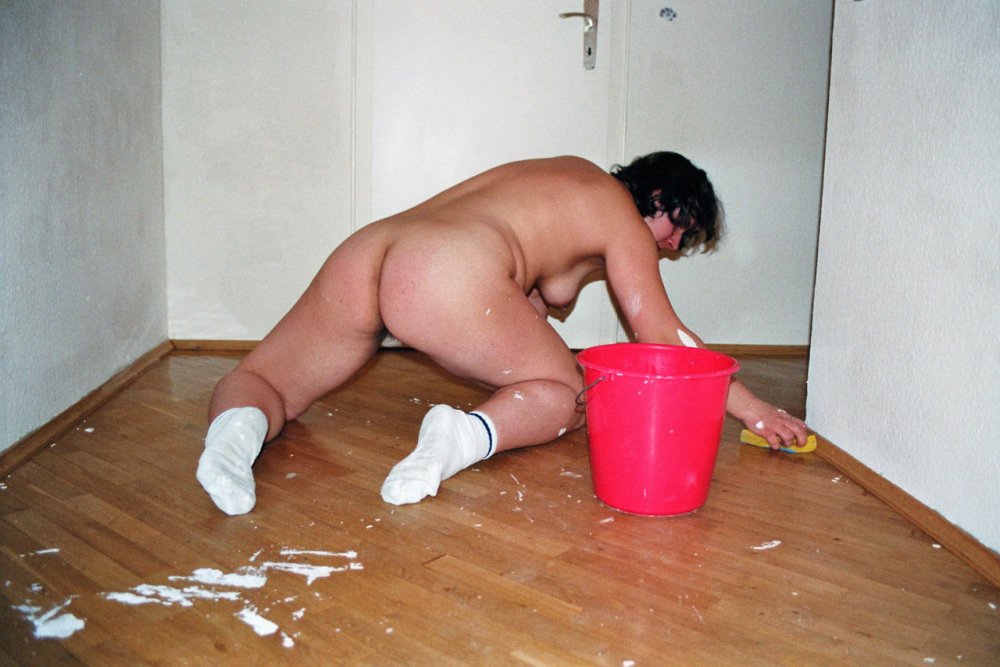 Naked women clean the house