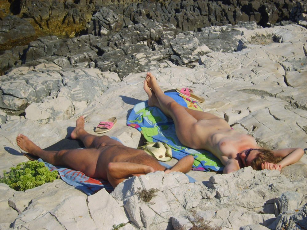 Mature sunbathing on a deck chair