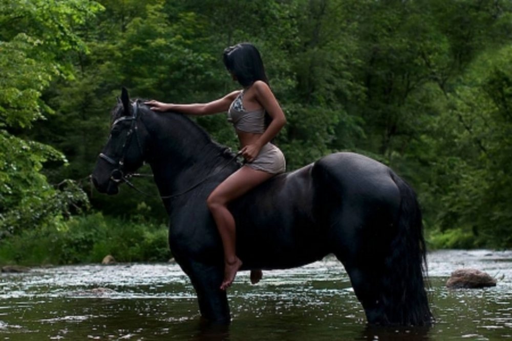 Naked blonde on a horse