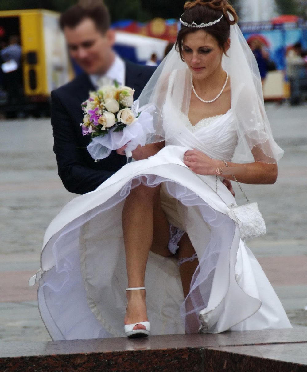 Bride in stockings in the fountain