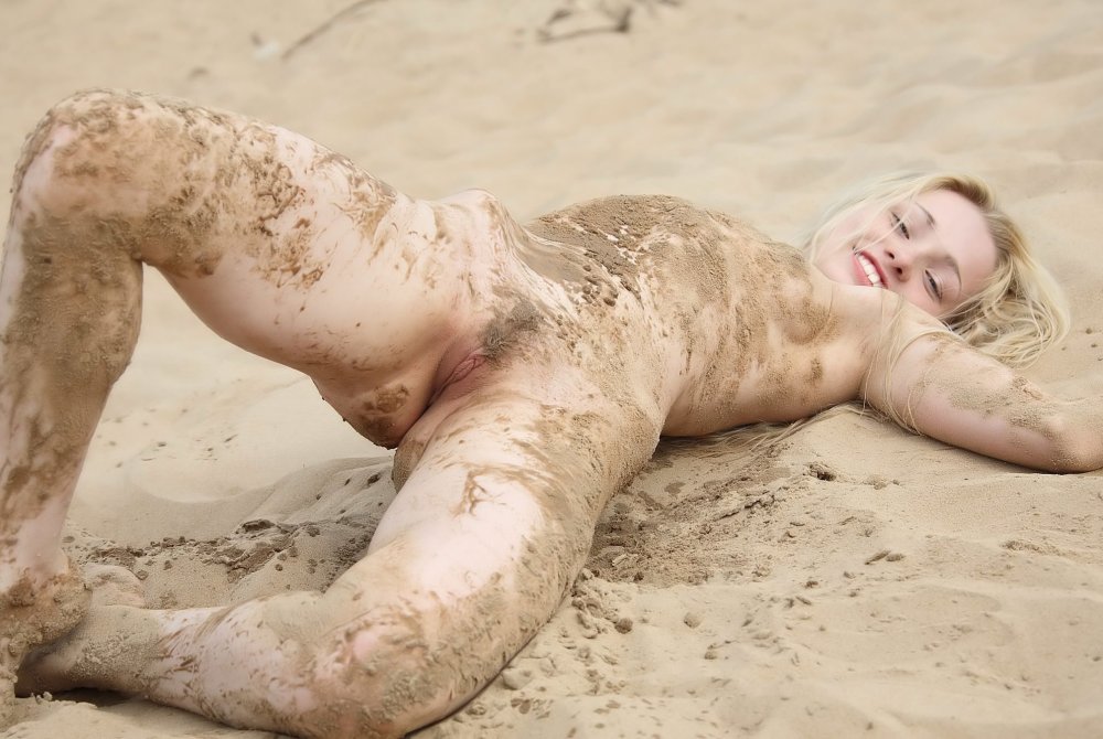 Naked woman all in mud