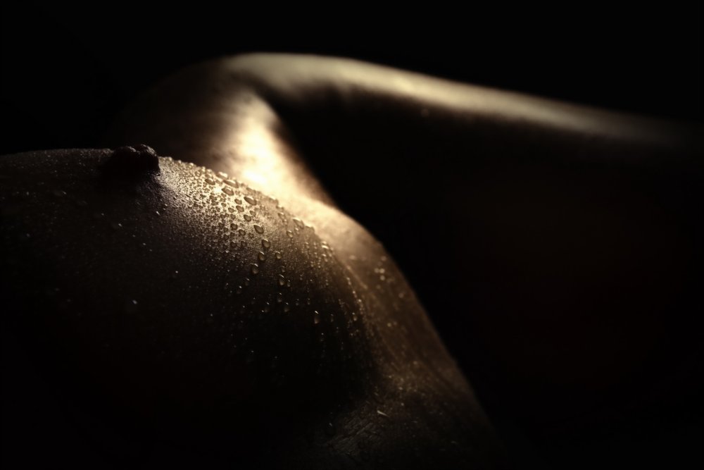 Women's breasts in drops of water