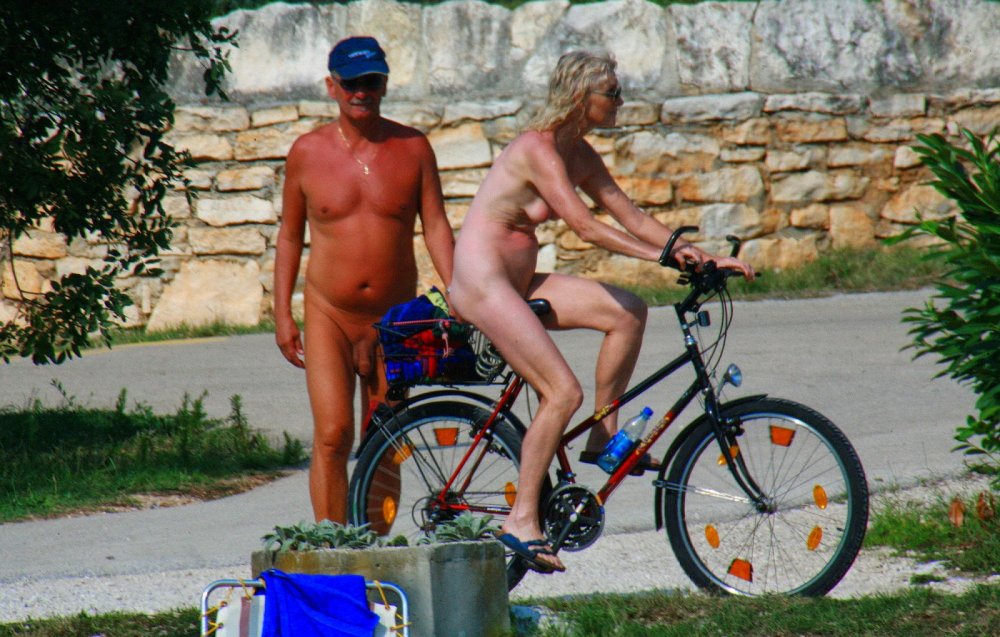 Naked mother with daughter on the beach