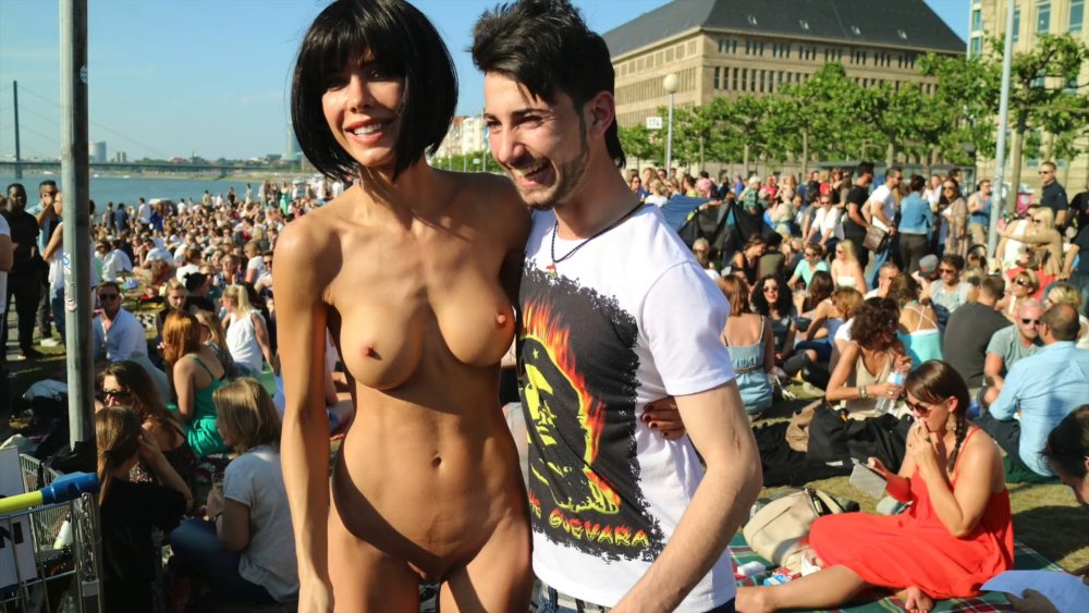 Naked woman among dressed