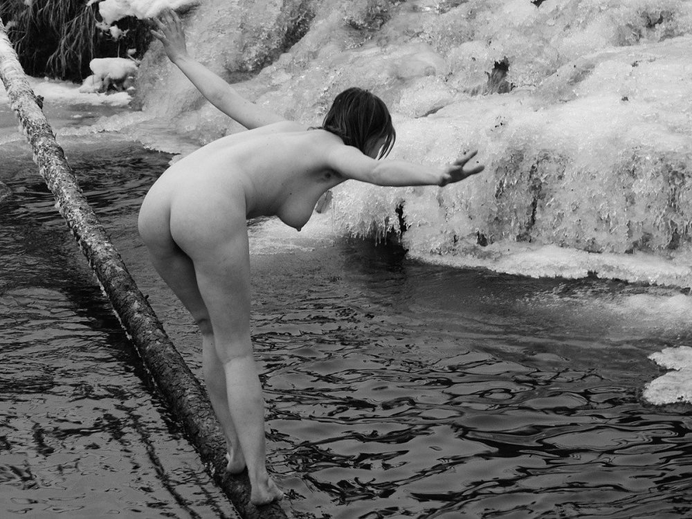 Bare women bathe in the river