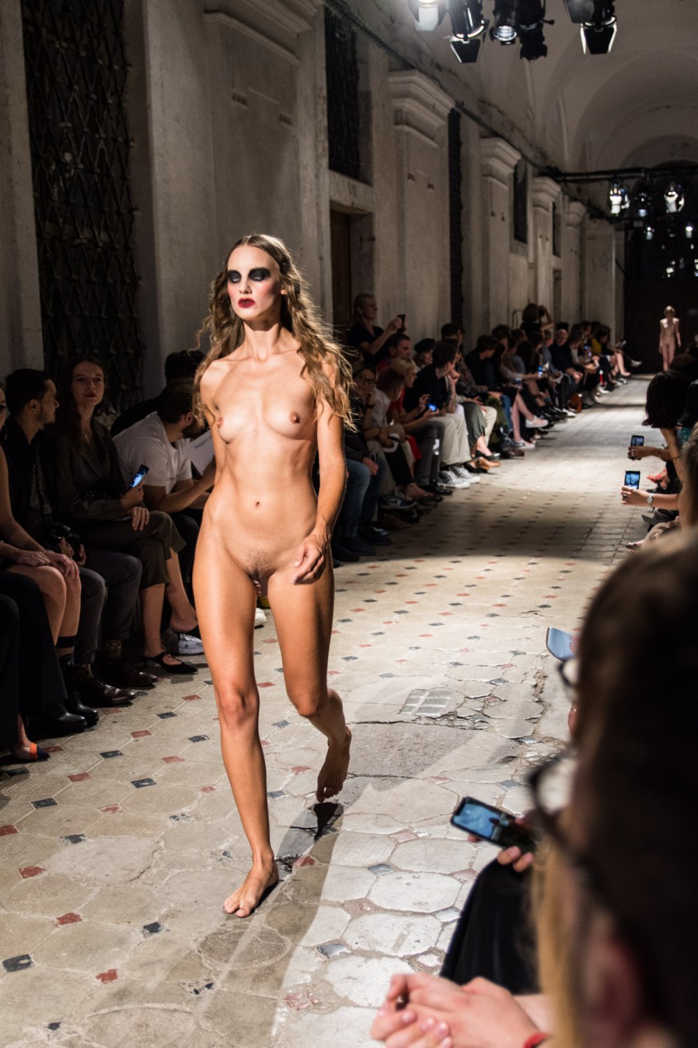 Naked fashion models on the podium