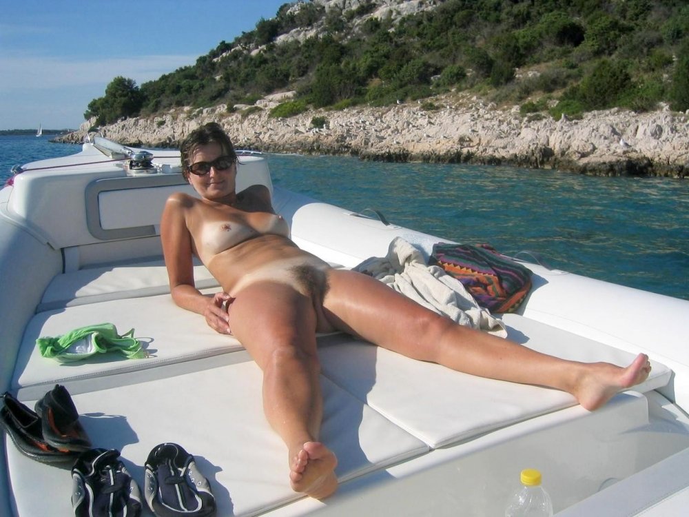 Tanned nudist on the shore