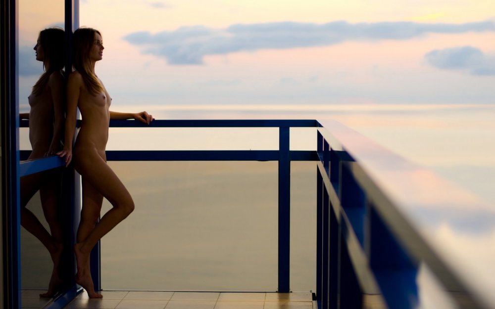 Topless girl on the balcony