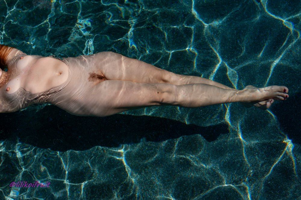 Mature float naked in transparent water