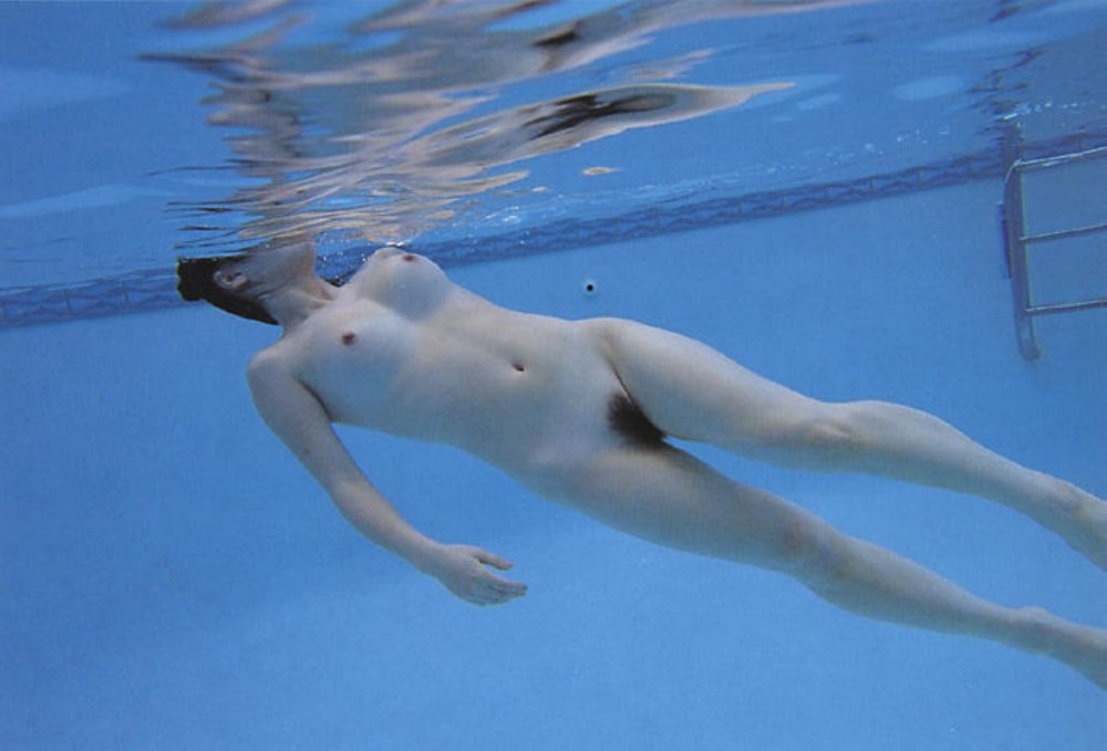 Naked women swim in the pool