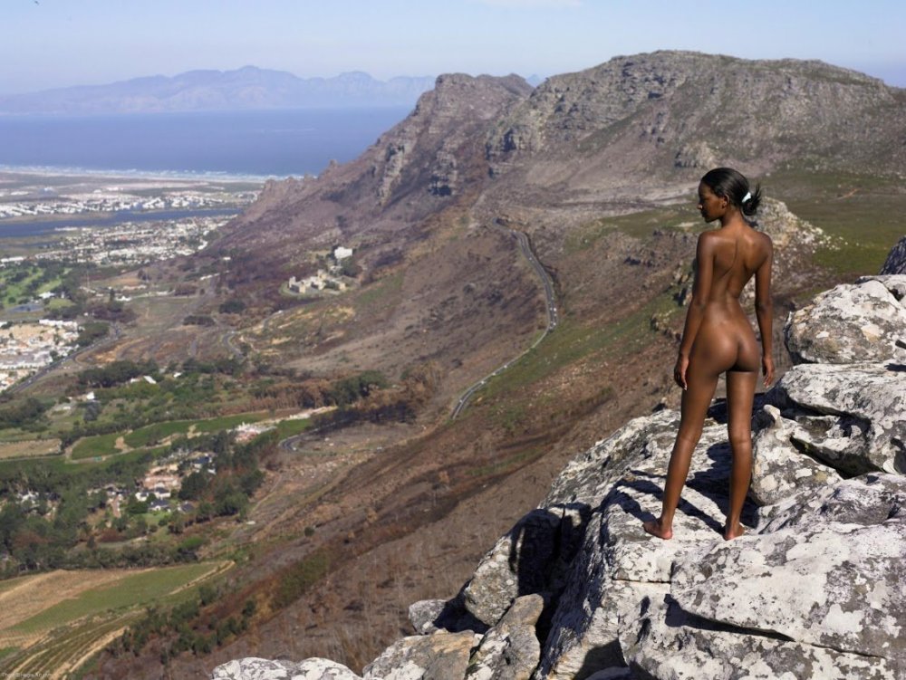 Naked woman on the top of the mountain