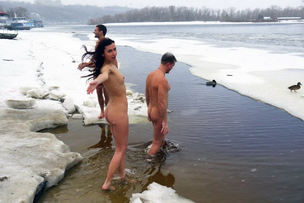 Naked men bathe in the hole