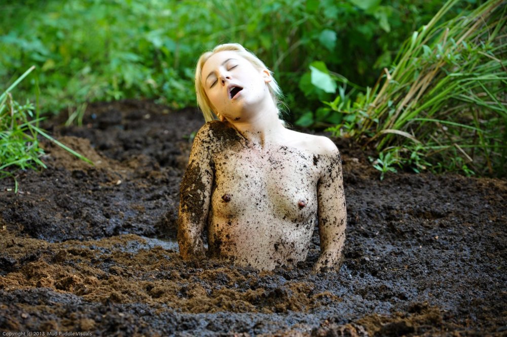 Girl in mud without clothes