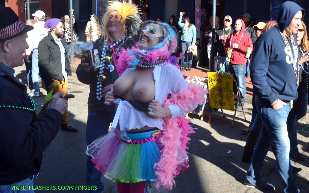 Women show breasts for beads