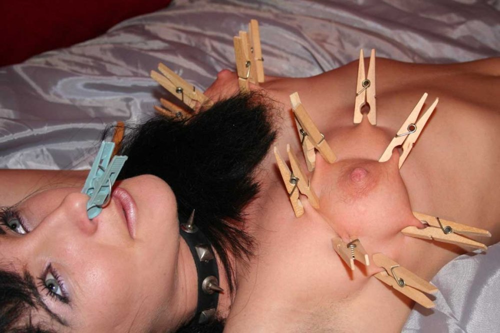 Girl with clothespins on tits