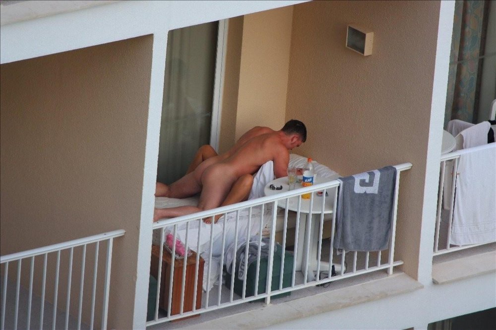 Beautiful naked woman on the balcony