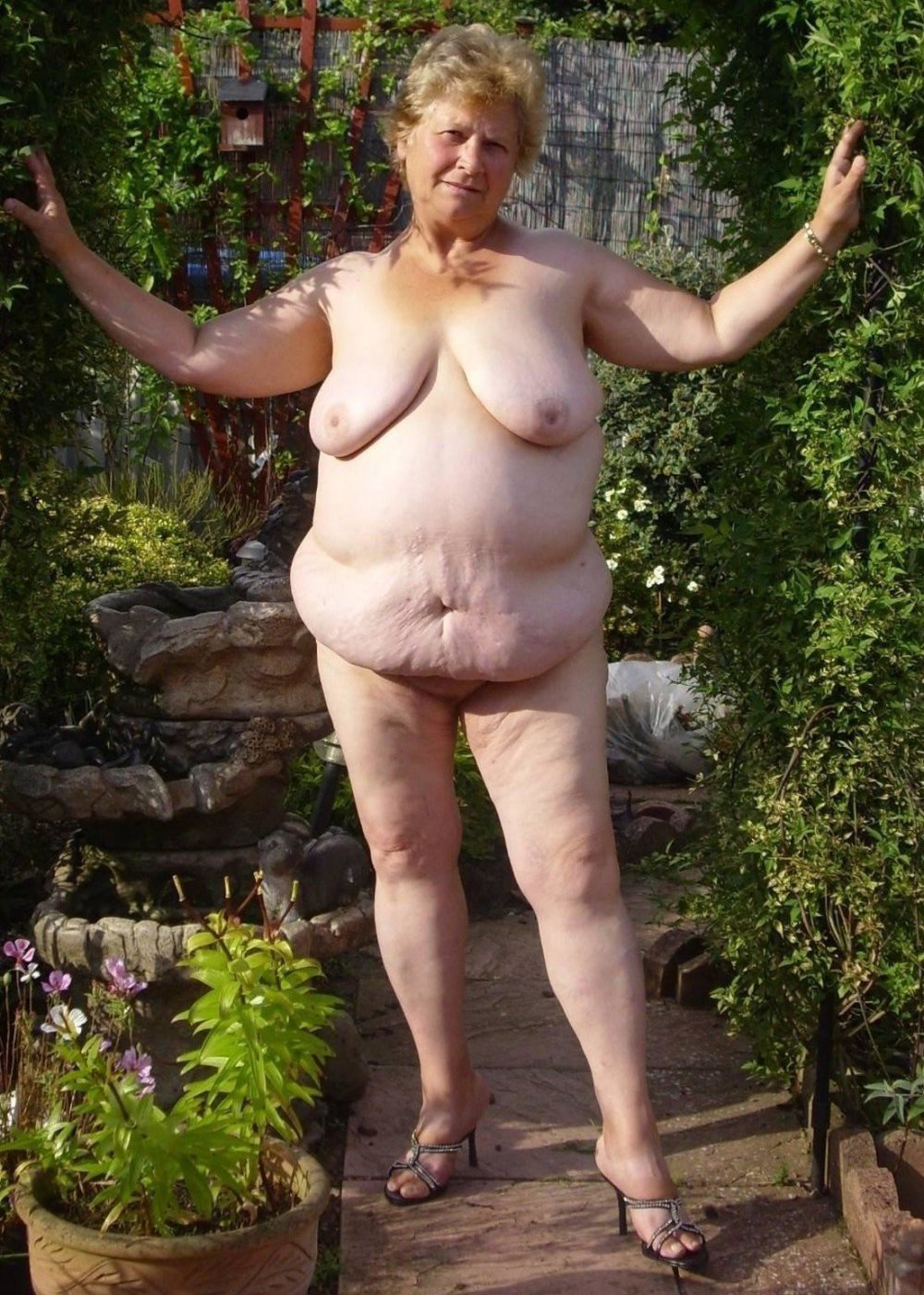 Bare mature women in the garden