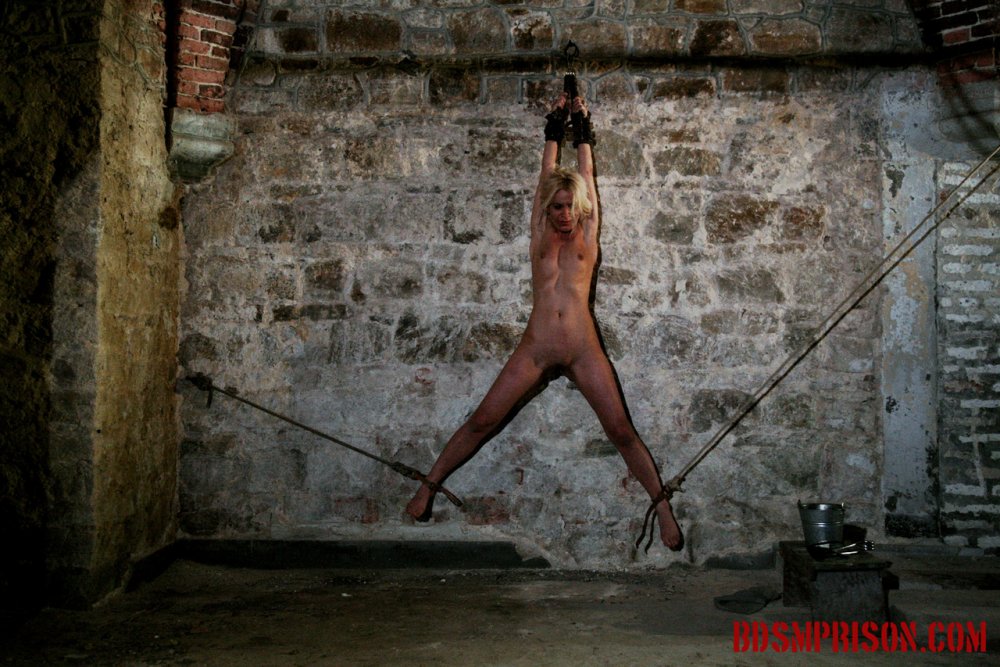 A naked woman is tortured in prison