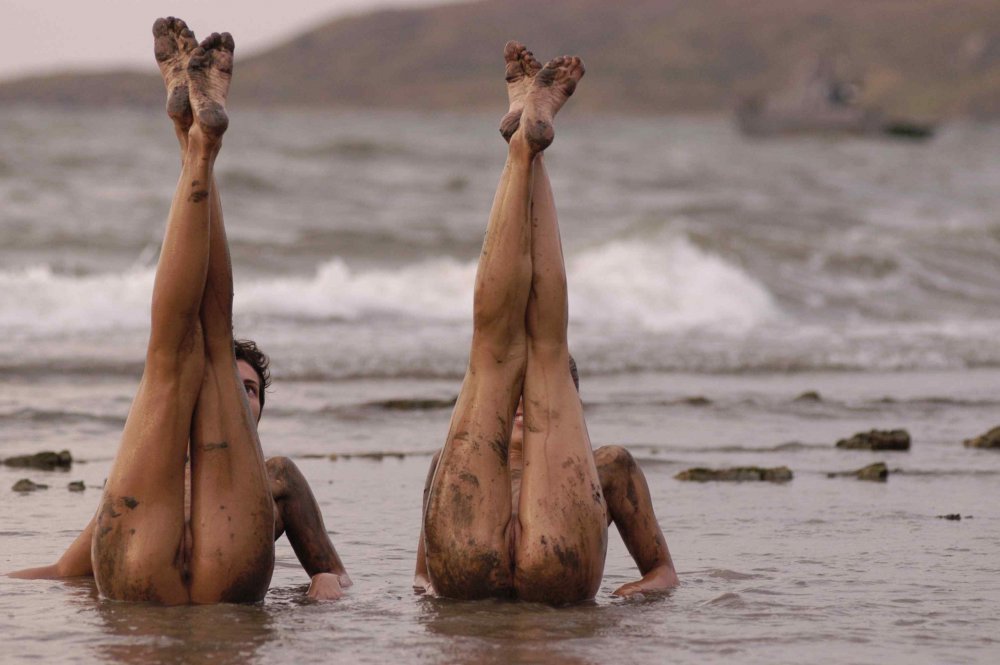 Naked girls bathed in mud