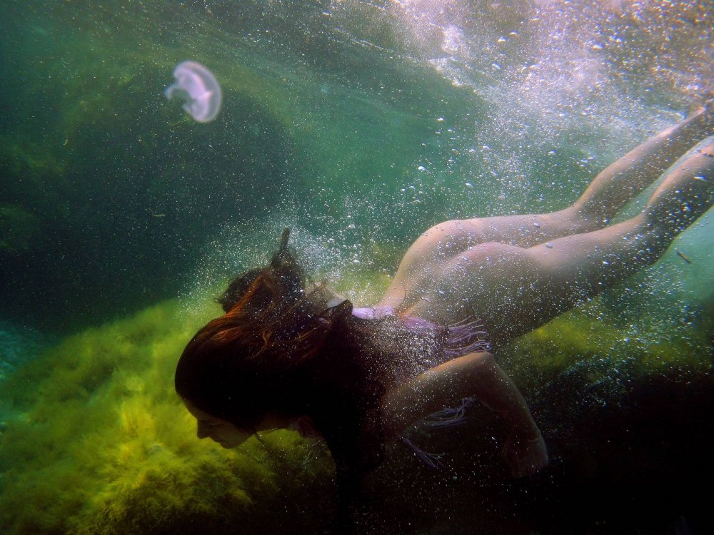 Naked mermaids under water