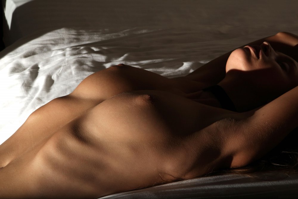 Naked female body in the dark