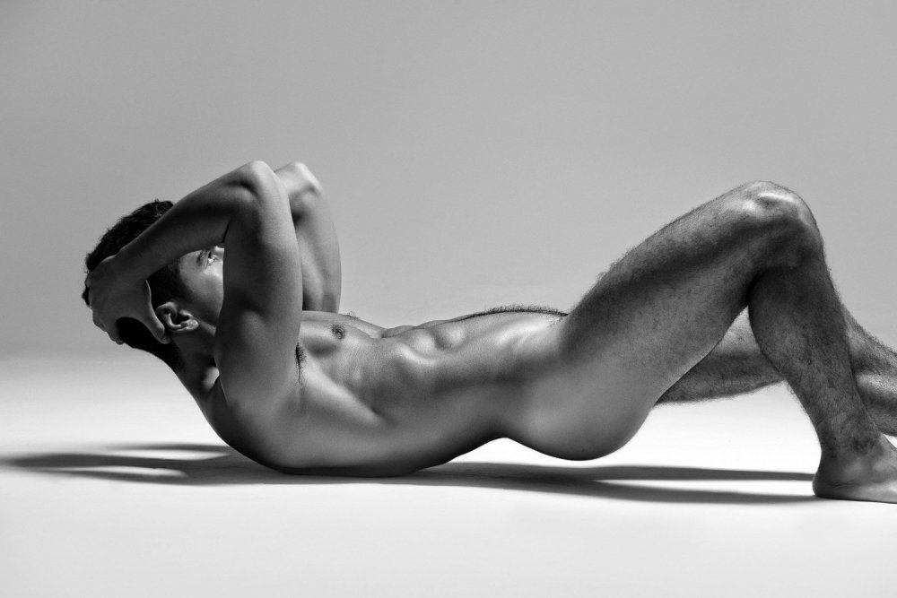 Naked man in front of the window