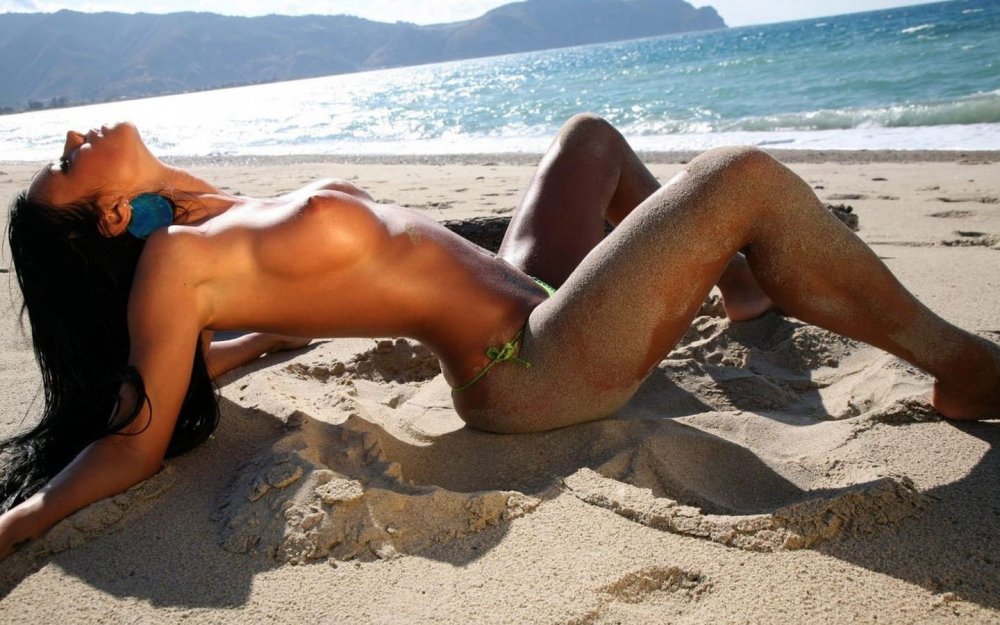 Girls sunbathe on the beach sexy