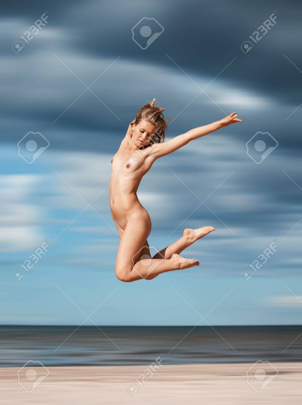 Naked brunettes in swimsuits on an empty beach