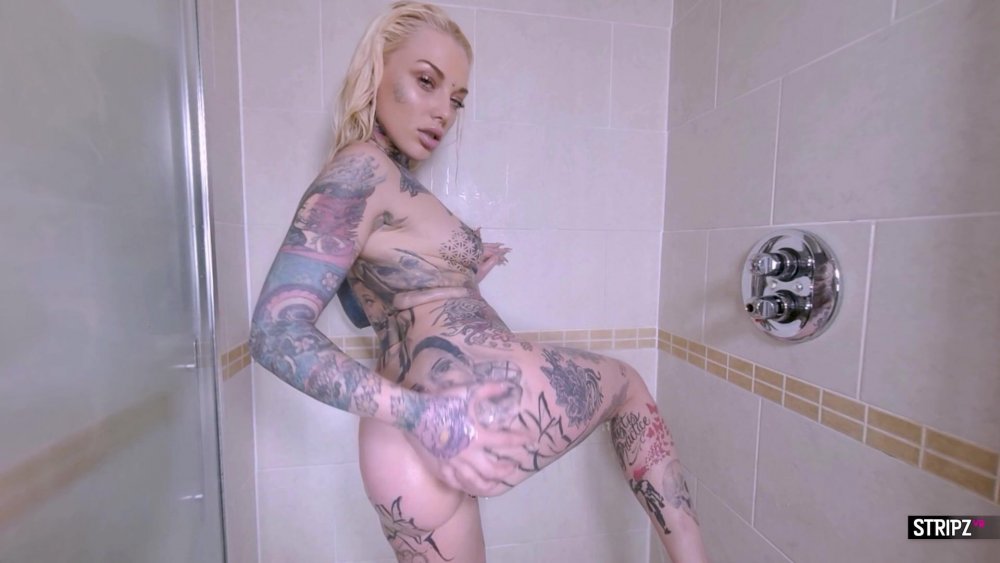 Busty blonde with tattoo