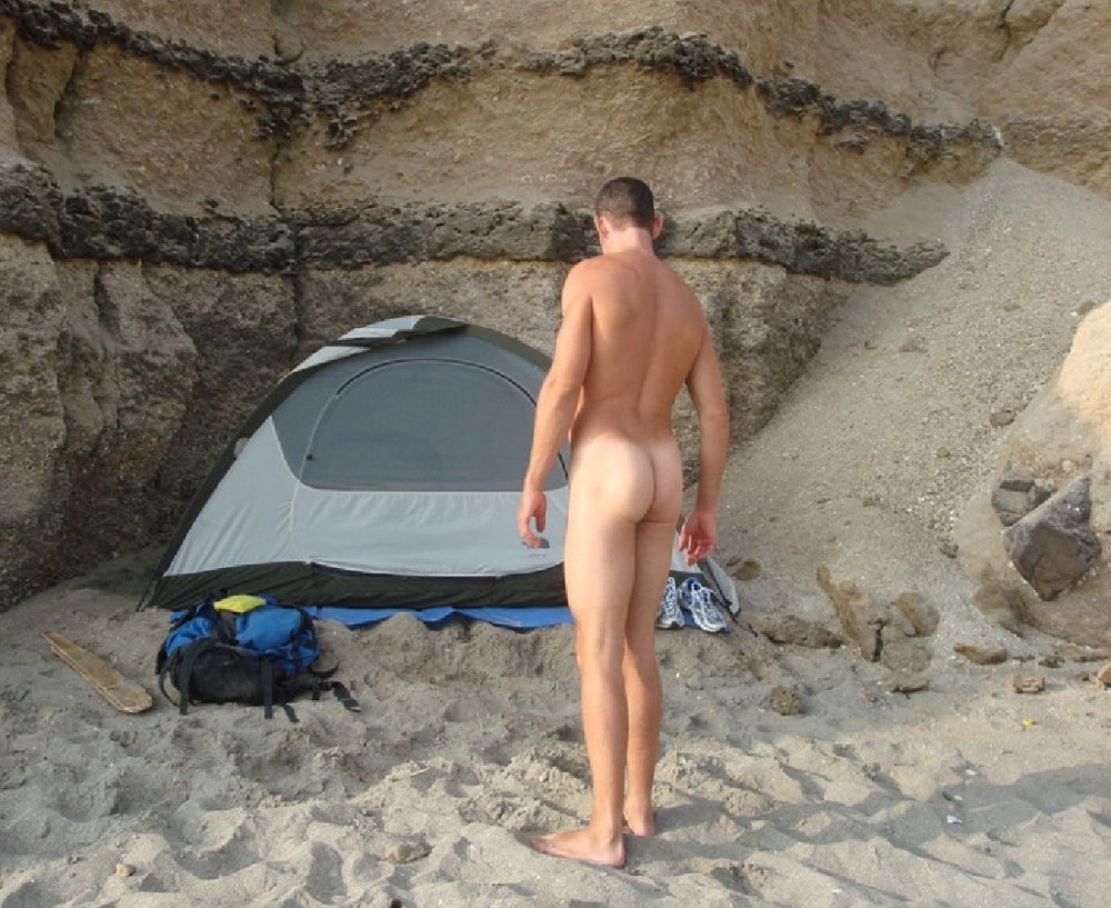 The guy sunbathes naked on the shore