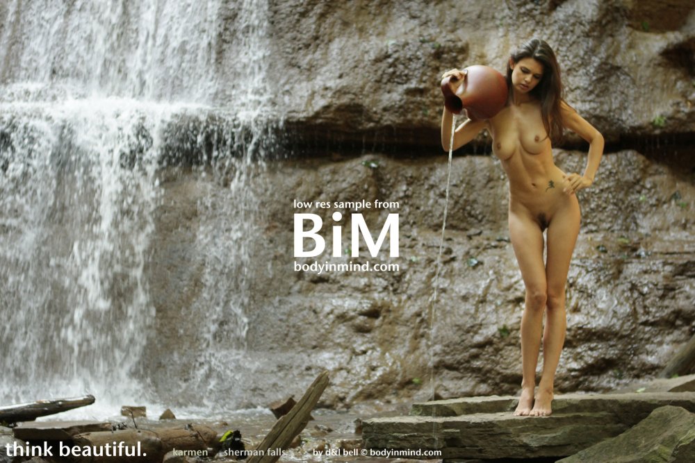 Naked girls on the background of a waterfall photo shoot