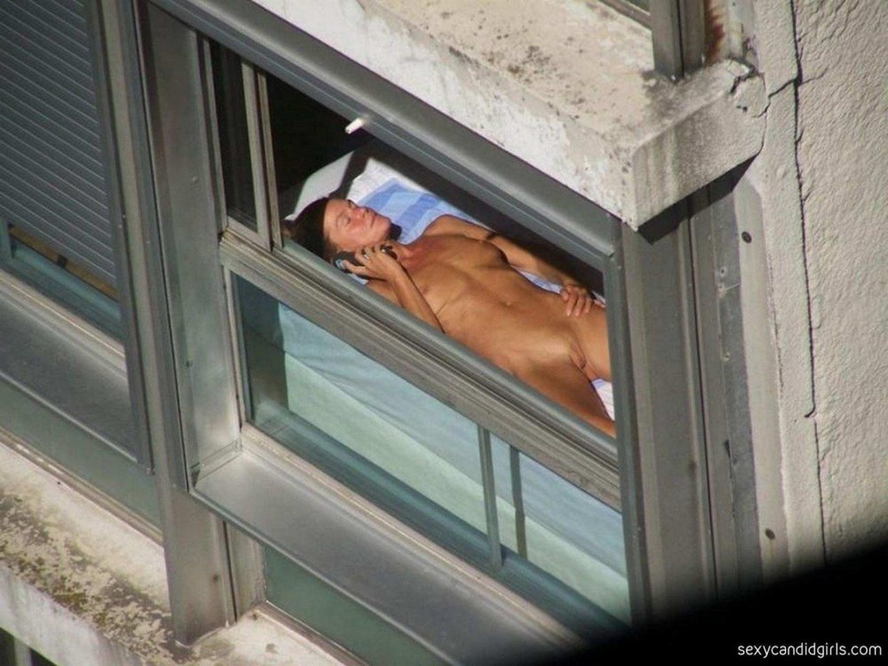 Naked women in the windows of houses