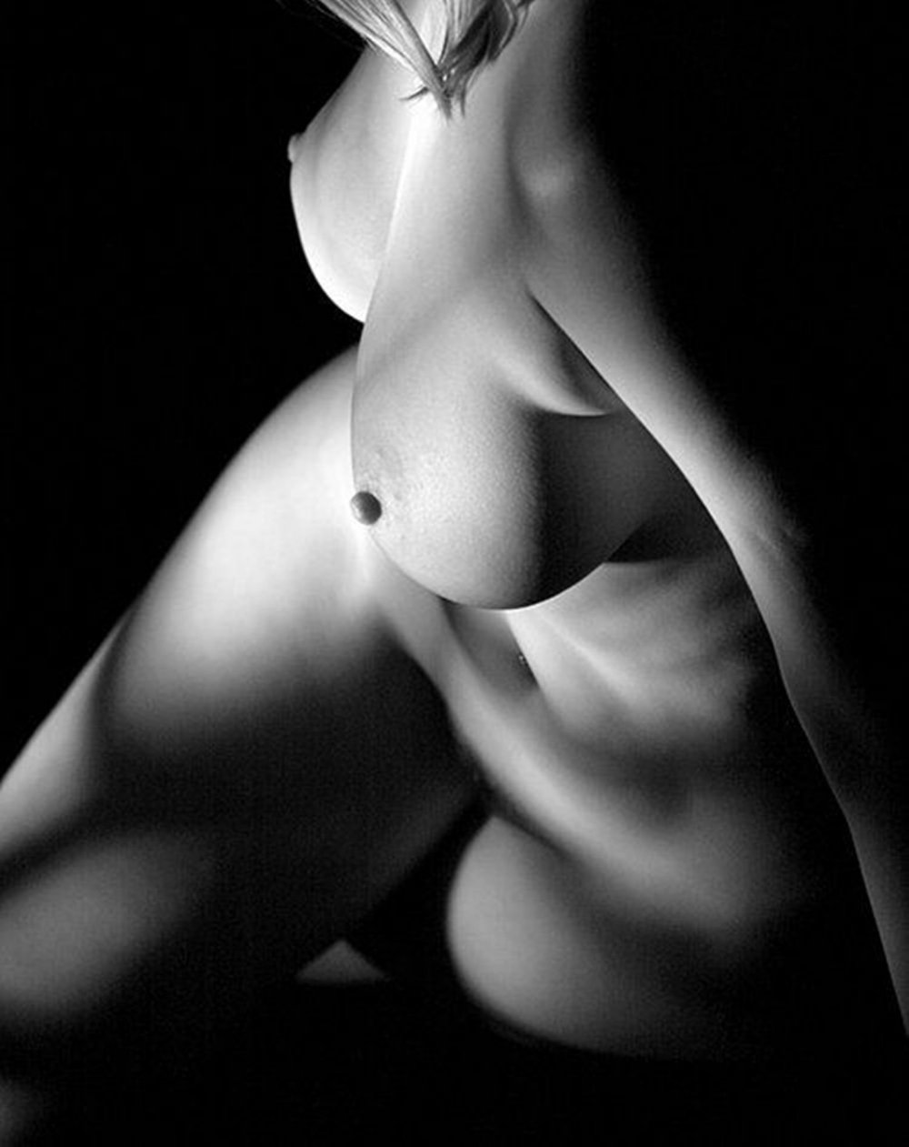 The naked chest of a woman who lies