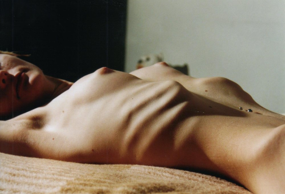 Naked woman in the pose of the bridge