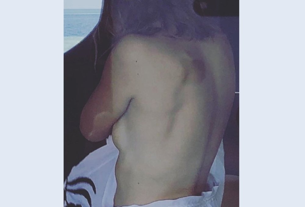 In a fur coat and underwear